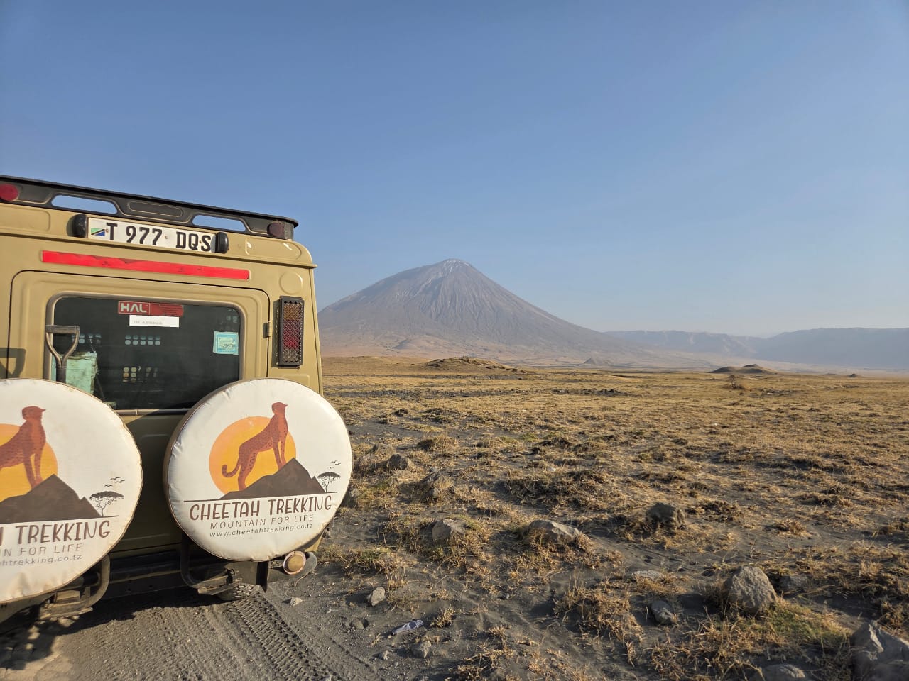 Cheetah Trekking safari vehicle beside a Tanzanian mountain