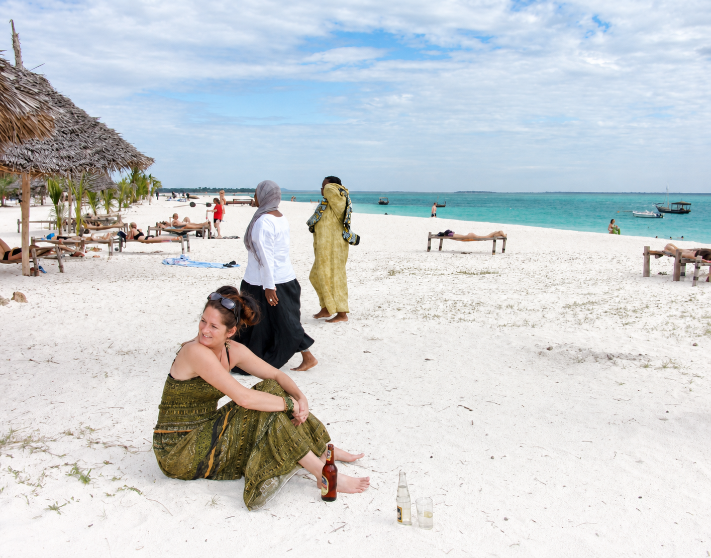 Travelers relaxing on a white-sand beach in Zanzibar