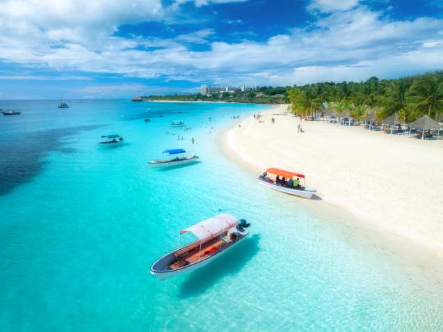 Turquoise Zanzibar beach with boats